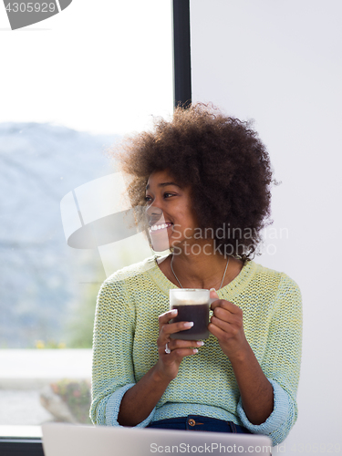 Image of black woman in the living room on the floor