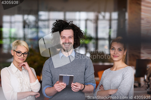 Image of group of Business People Working With Tablet in startup office