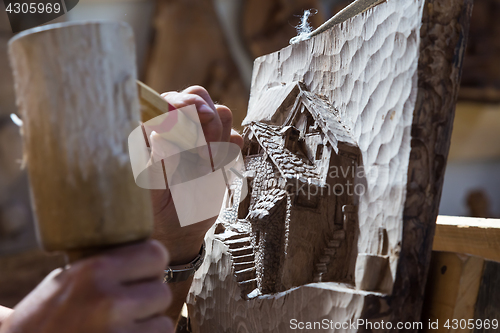 Image of Sculptor hands working wood