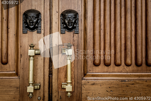 Image of Sphinx heads entrance on wooden door