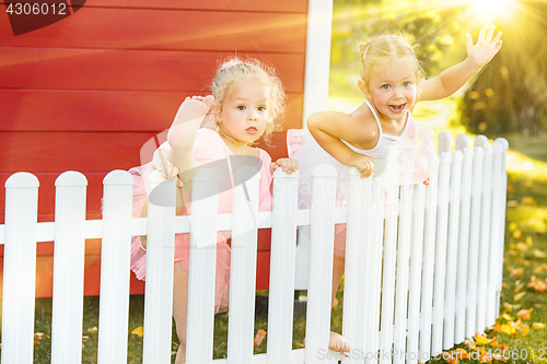 Image of The two little girls at playground against park or green forest