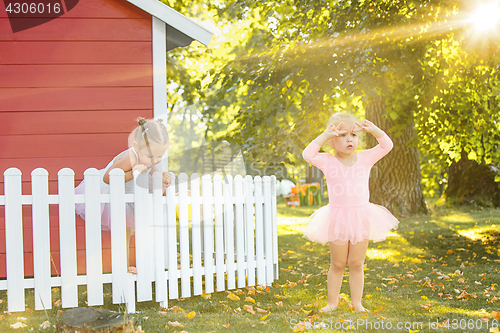 Image of The two little girls at playground against park or green forest