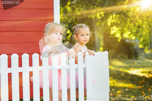 Image of The two little girls at playground against park or green forest