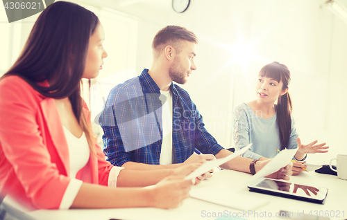 Image of happy creative team or students working at office