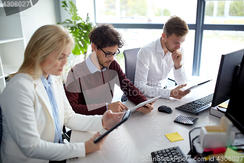 Image of business team with tablet pc at office