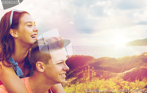 Image of happy teenage couple having fun outdoors