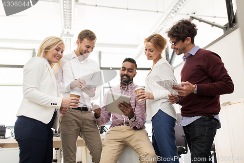 Image of business team with tablet pc and coffee at office