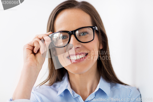 Image of close up of smiling middle aged woman in glasses