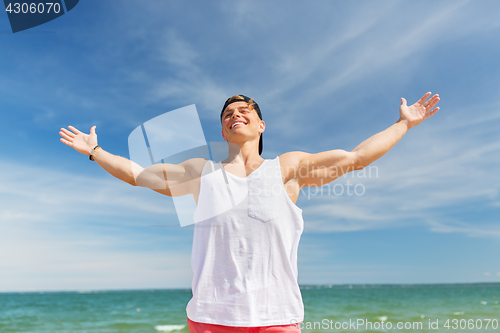 Image of smiling young man on summer beach