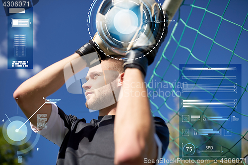 Image of goalkeeper with ball at football goal on field