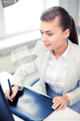 Image of businesswoman with drawing tablet in office