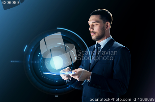 Image of businessman with tablet pc and virtual projection