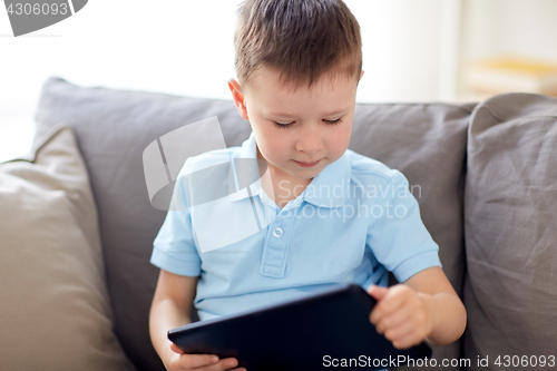 Image of little boy with tablet pc computer at home