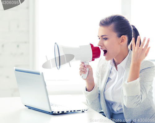 Image of strict businesswoman shouting in megaphone