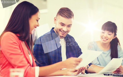 Image of happy creative team or students working at office