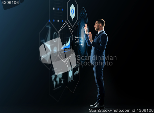 Image of businessman working with virtual projection