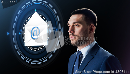 Image of businessman with e-mail message hologram