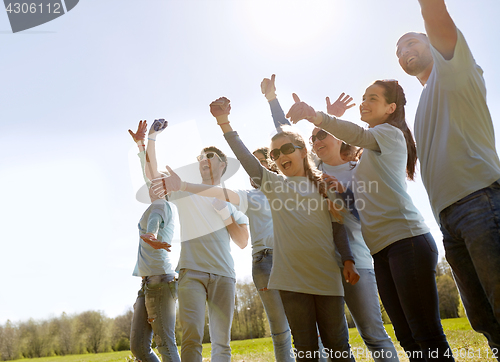 Image of group of volunteers celebrating success in park