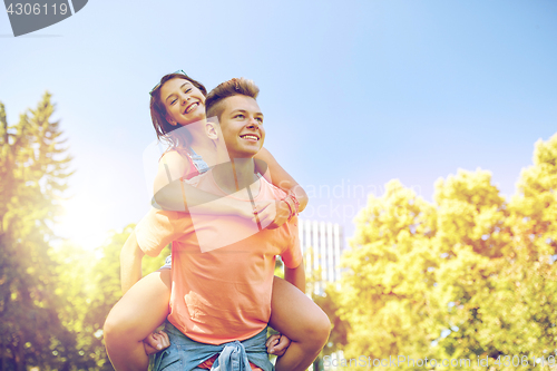 Image of happy teenage couple having fun at summer park