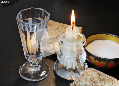 Image of Shot glass, bread and candlestick