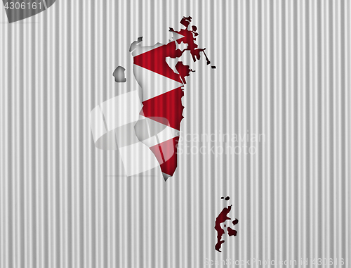 Image of Map and flag of Bahrain on corrugated iron