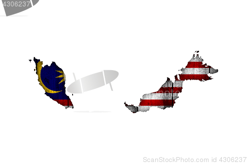 Image of Map and flag of Malaysia on weathered wood