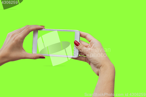 Image of Young girl hand holding mobile smart phone on green screen