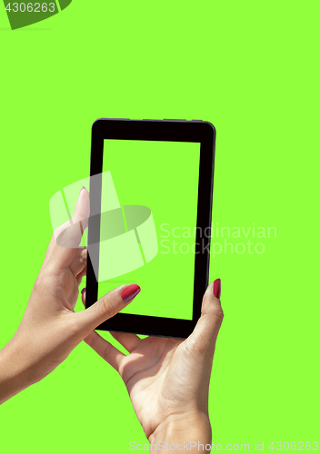 Image of Young girl hand holding a tablet on green screen