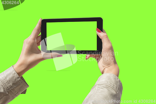 Image of Young girl hand holding a tablet on green screen