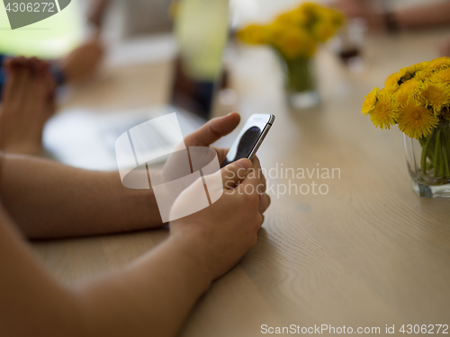 Image of Young man holding smartphone