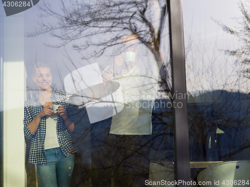 Image of young couple enjoying morning coffee