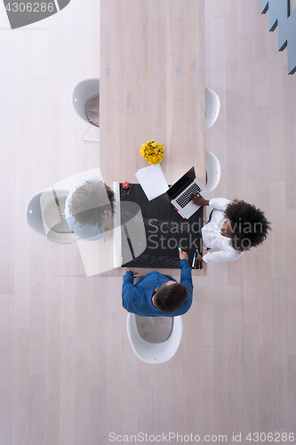 Image of top view of Multiethnic startup business team on meeting