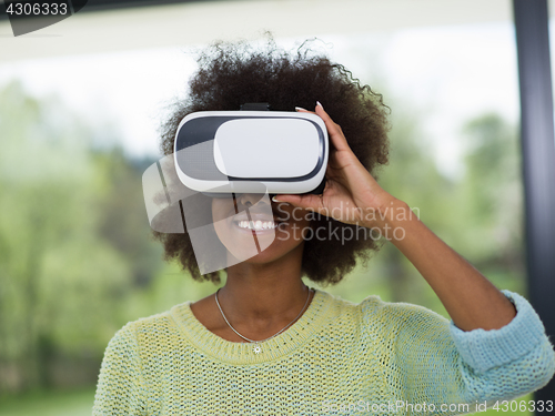 Image of black woman using VR headset glasses of virtual reality