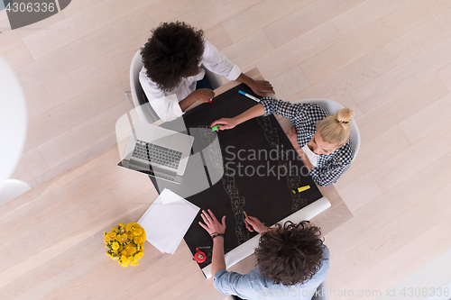 Image of top view of Multiethnic startup business team on meeting