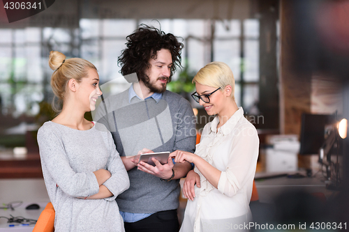 Image of group of Business People Working With Tablet in startup office