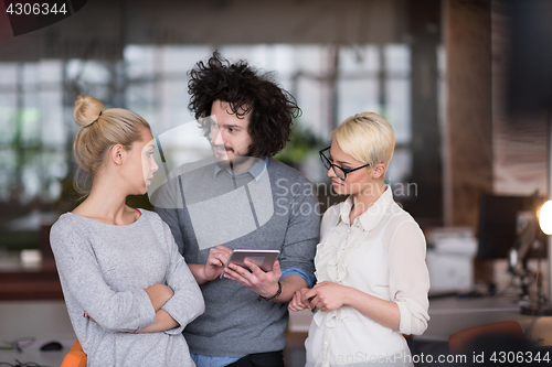 Image of group of Business People Working With Tablet in startup office