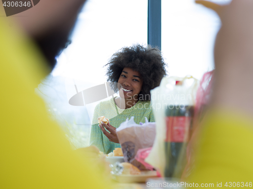 Image of multiethnic group of happy friends lunch time