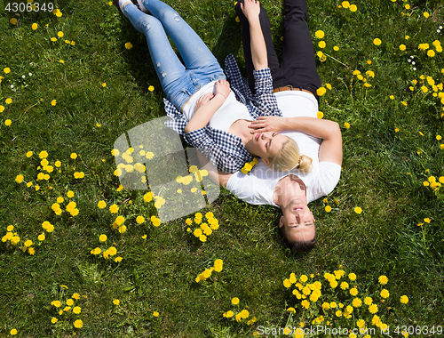 Image of man and woman lying on the grass