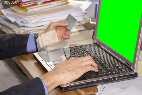 Image of Business man shopping online, using laptop and credit card on gr