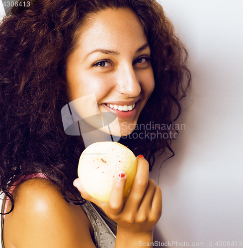 Image of pretty young real tenage girl eating apple close up smiling