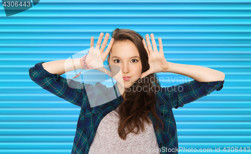 Image of happy teenage girl making face and having fun