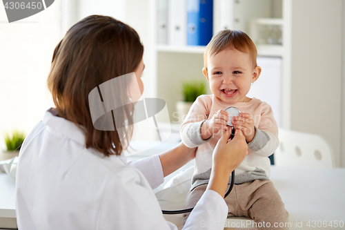 Image of doctor with stethoscope and happy baby at clinic