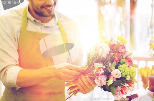 Image of close up of florist man with bunch at flower shop