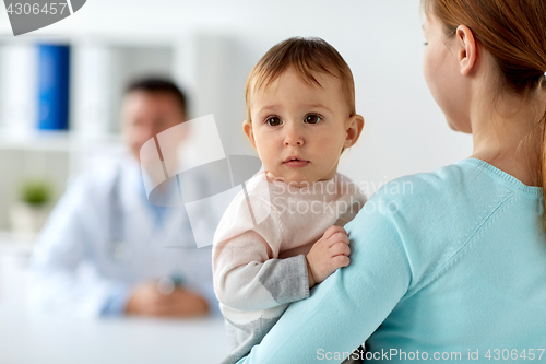 Image of close up of mother with baby and doctor at clinic