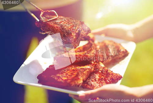 Image of man cooking meat at summer party barbecue