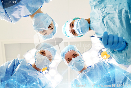 Image of group of surgeons in operating room at hospital