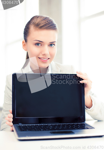 Image of businesswoman with laptop in office