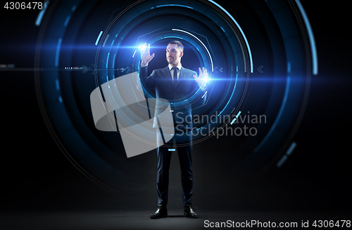Image of businessman in suit with virtual projection