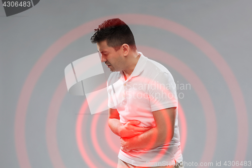 Image of unhappy man suffering from stomach ache