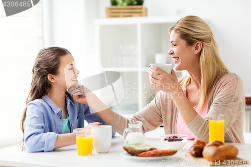 Image of happy family having breakfast at home kitchen